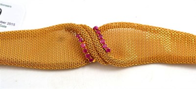 Lot 19 - An 18ct gold mesh bracelet, woven in a graduated form, and claw set with two rows of pinkish...