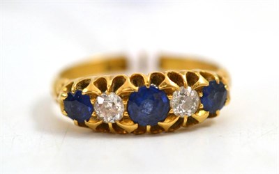 Lot 21 - An 18ct gold sapphire and diamond ring, three graduated round cut sapphires alternate with old...