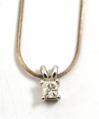 Lot 22 - A diamond solitaire pendant, the princess cut diamond in a white four claw setting on a split...