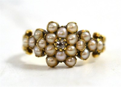 Lot 29 - A diamond and pearl cluster mourning ring, an old cut diamond centres a split seed pearl...