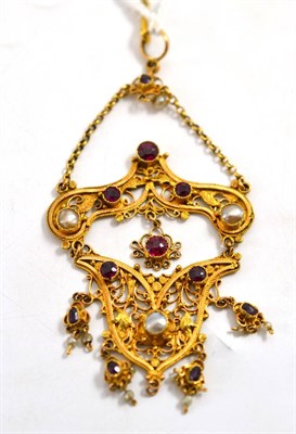 Lot 31 - A decorative pendant set with rubies and pearls, in Eastern style, of scrolling form, with leaf...