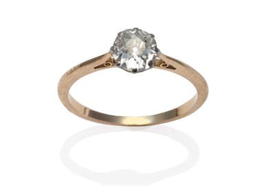 Lot 32 - A diamond solitaire ring, the old cut diamond in a white claw setting to a yellow tapered...