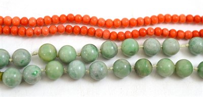 Lot 42 - A jade bead necklace, length 70cm and a coral bead necklace, length 66cm approximately (2)