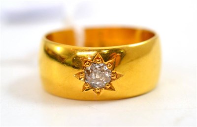 Lot 48 - A 22ct gold band ring, inset with an old cut diamond estimated to weigh 0.50 carat...