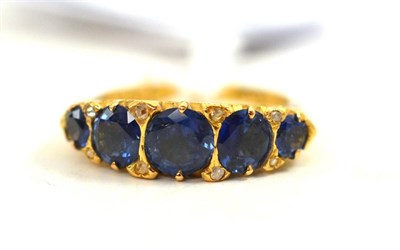 Lot 49 - An 18ct gold sapphire five stone ring, the mixed cut sapphires spaced by pairs of rose cut...