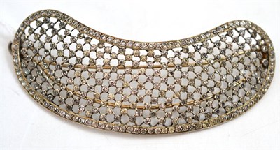 Lot 51 - A hair ornament, of curved form, with white paste stones inset in grid fashion linked by fine bars