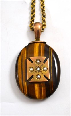 Lot 57 - A tiger's-eye locket set with seed pearls within a Maltese cross panel, and a fancy link...