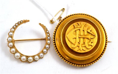 Lot 72 - A Victorian brooch, of disk form, with beaded border, and entwined initials 'EIA' to the...