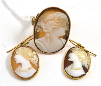Lot 73 - A cameo ring and a pair of earrings, each depicting a classical maiden's head, in a plain oval...