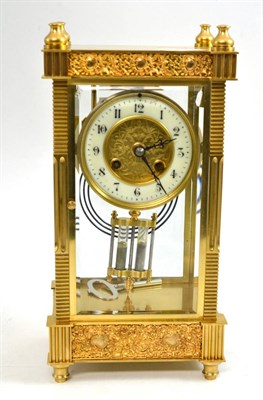 Lot 90 - A brass four glass striking mantel clock, circa 1900, enamel Arabic chapter ring, twin barrel...