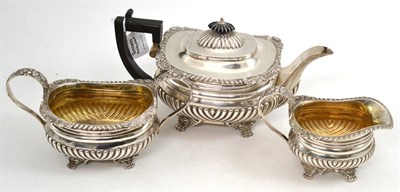 Lot 93 - An Edward VII silver three piece tea set, Munsey & Co, London 1905, comprising teapot, cream...