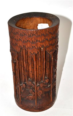 Lot 104 - A 19th century Chinese bamboo brush pot, carved with scribes amidst bamboo, 21cm high