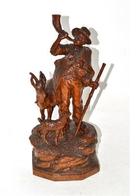 Lot 110 - A Swiss ";Black Forest"; carved wood group, late 19th/early 20th century, of a herdsman with a horn