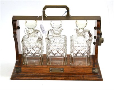 Lot 115 - Edwardian oak and silver plated three bottle tantalus