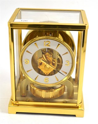 Lot 126 - An atmos clock, signed Jaeger LeCoultre, 20th century, white chapter ring with a skeletonised...