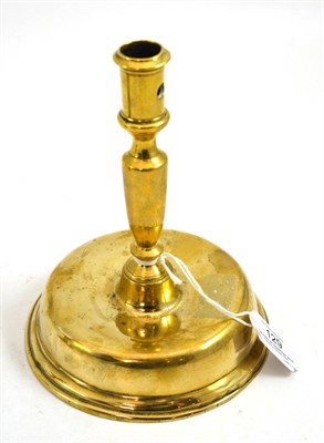 Lot 129 - A late 17th century brass candlestick, Low Countries, circa 1680, the broad hollow domed foot...