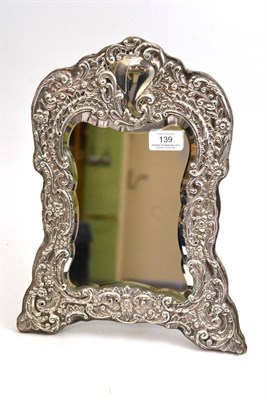 Lot 139 - A Victorian silver easel mirror, Henry Matthews, Birmingham 1900, the shaped rectangular...