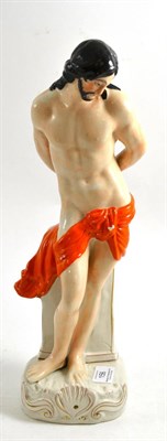 Lot 156 - A Staffordshire pottery figure of St Sebastian, circa 1870, standing before a column on a shell and