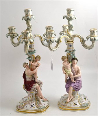 Lot 164 - A pair of Meissen porcelain figural three branch candelabra, circa 1900, each with a mother holding