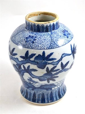 Lot 165 - A Chinese porcelain baluster jar decorated in underglaze blue with fruiting peach trees, bears...