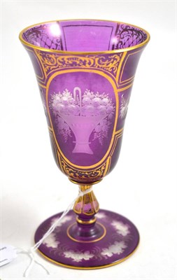 Lot 169 - Bohemian amethyst overlay clear glass wine glass, 19th century, the shaped bowl engraved with...