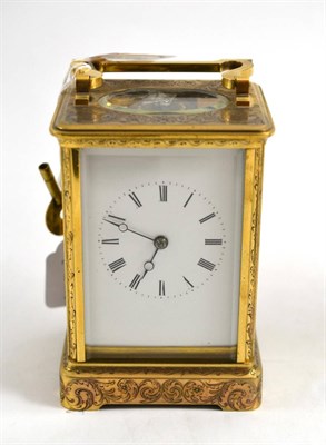 Lot 176 - A engraved brass striking carriage clock, circa 1890, case engraved with floral and scroll...