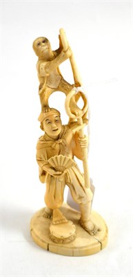 Lot 178 - A Japanese ivory okimono, Meiji Period, as a standing man with a monkey on his head holding a...