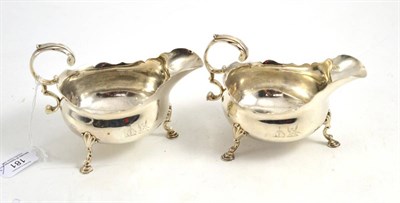 Lot 181 - A pair of George III silver sauce boats, John Munns, London 1760, engraved with two crests