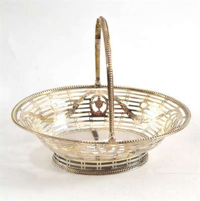 Lot 186 - A small pierced silver bonbon dish with swing handle, London, probably 1777, with Neo Classical...