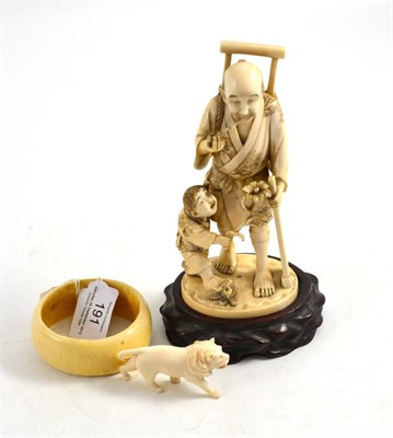 Lot 191 - A late 19th/early 20th century Japanese ivory okimono of a man smoking a pipe, a boy as his...