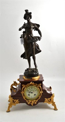 Lot 203 - A red marble and spelter striking mantel clock, circa 1910, bronzed spelter figure and gilt...