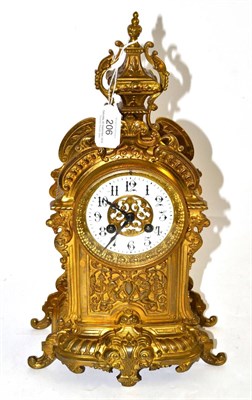 Lot 206 - A gilt metal striking mantel clock, circa 1900, case with scroll and lion masks, enamel chapter...