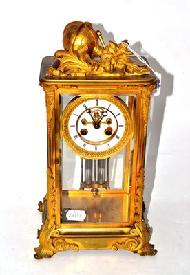 Lot 208 - A gilt metal four glass striking mantel clock, circa 1900, surmounted with a globe and...