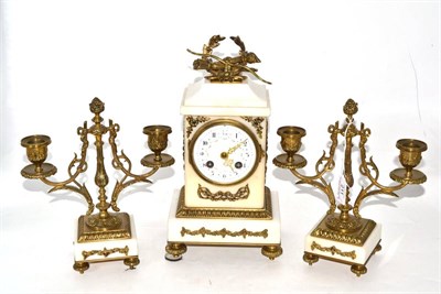 Lot 211 - A white marble striking mantel clock with garniture, circa 1910, gilt metal mounts, enamel dial...