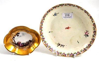 Lot 218 - A Meissen porcelain quatralobe saucer painted with figures in a landscape on a gilt ground,...