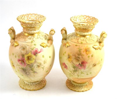 Lot 234 - Pair of Grainger Worcester twin handled-vases, circa 1900, painted with flowers on a blue ivory...