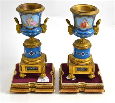 Lot 235 - A pair of gilt metal mounted Sevres style campana urns, late 19th century, painted with...