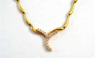 Lot 240 - A diamond set necklace, of drop shaped polished yellow links, to a centre of round brilliant...