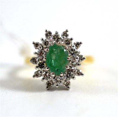 Lot 243 - An 18ct gold emerald and diamond cluster ring, the oval cut emerald within a border of round...