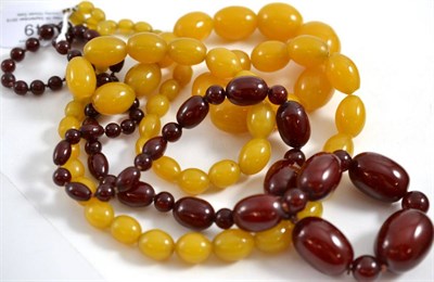 Lot 249 - An amber necklace, the cherry red graduated barrel shaped beads alternate with round beads,...