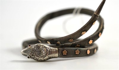 Lot 252 - A snake bangle, of meshed white metal overlaid at intervals with yellow floral motifs