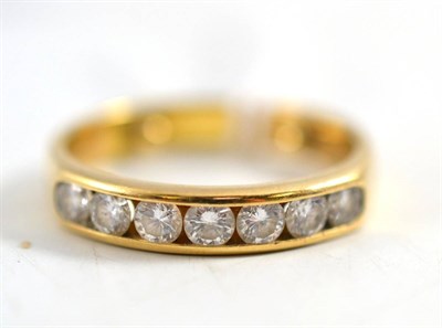 Lot 269 - A diamond half hoop ring, seven round brilliant cut diamonds in a yellow channel setting, total...