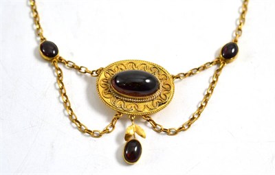 Lot 295 - A cabochon garnet set necklace, the central panel inset with an oval cabochon garnet, within...