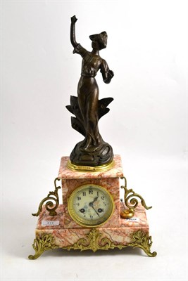 Lot 311 - A pink marble striking mantel clock, circa 1910, bronzed spelter figure and applied gilt metal...