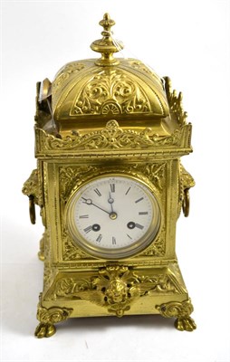 Lot 315 - A gilt metal striking mantel clock, circa 1910, scroll panels, ringed lion head side handles,...