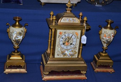 Lot 318 - A gilt metal and ceramic mounted striking mantel clock with garniture, circa 1900, ceramic dial...