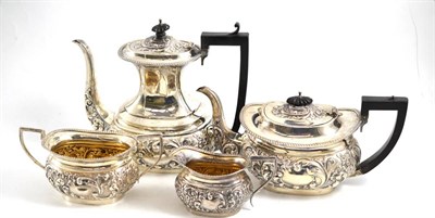 Lot 336 - A four piece silver tea and coffee service, each piece heavily chased with cartouches, scrolls...