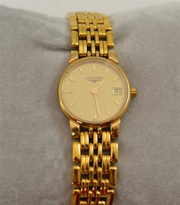 Lot 338 - A lady's calendar plated wristwatch, signed Longines, circa 2000, quartz movement, dial with dagger