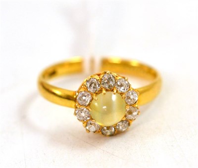 Lot 371 - A cat's-eye chrysoberyl and diamond cluster ring, the cabochon cat's-eye within a border of old cut