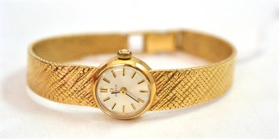 Lot 381 - A lady's 9ct gold wristwatch, signed Omega, circa 1965, lever movement, silvered dial with...